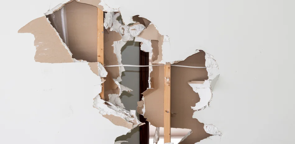 A hole in a wall that has been torn open