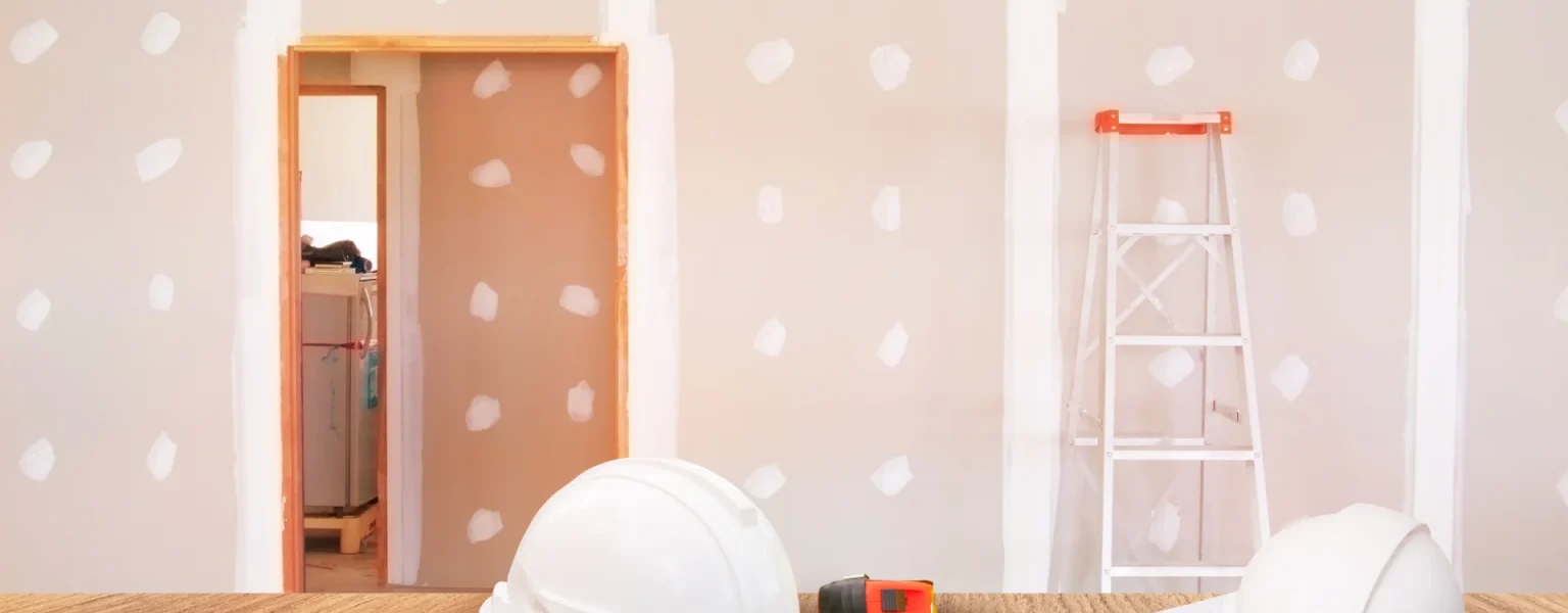 A room with a ladder, paint rollers, and a ladder