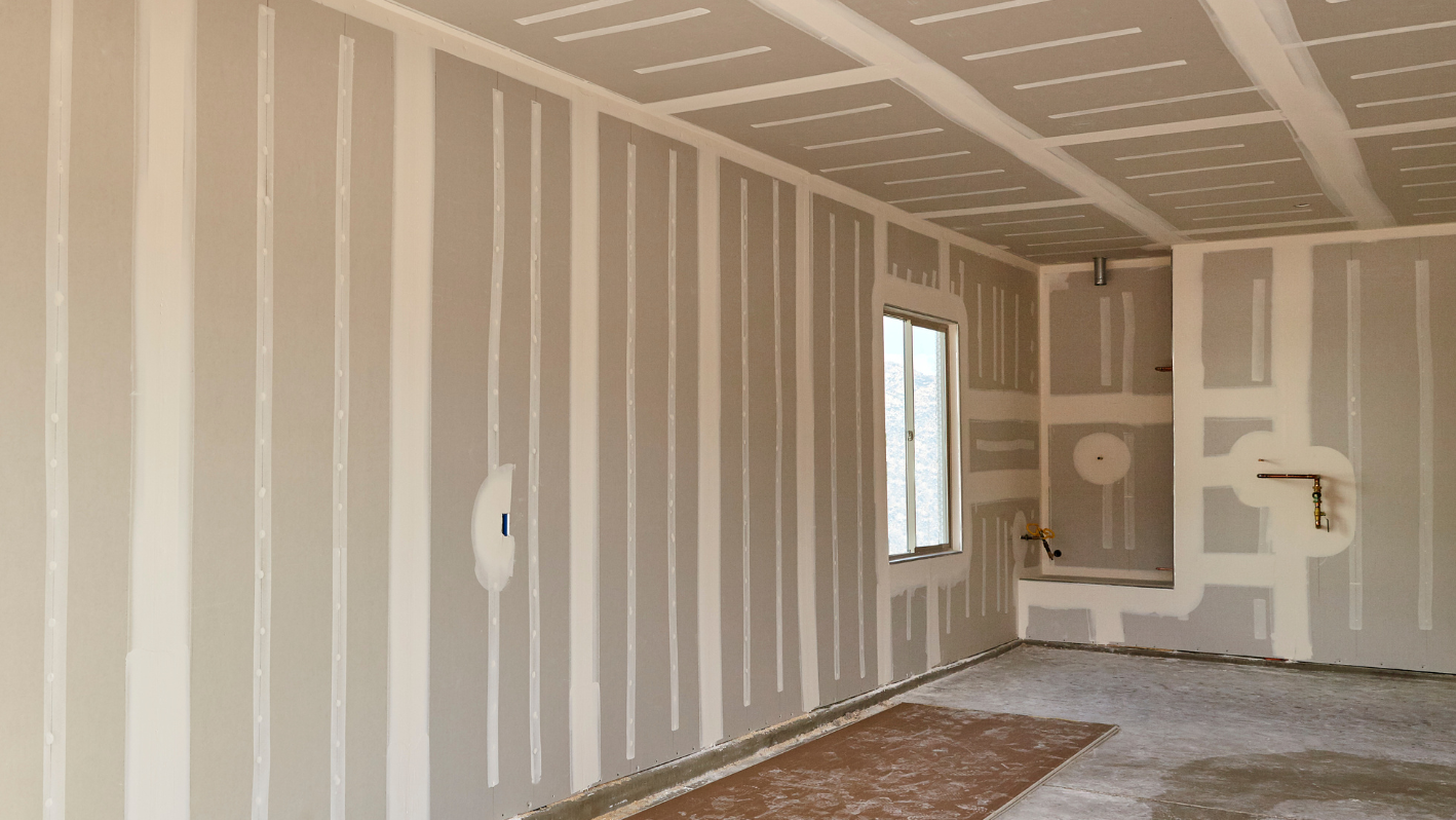 A room that is being painted with white paint